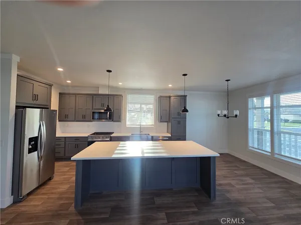 a kitchen with a refrigerator sink and cabinets