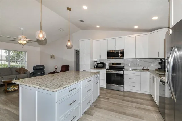 a kitchen with a sink stainless steel appliances and cabinets