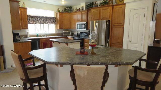 4275 East Aztec Road Rimrock, AZ 86335 - Photo 5 of 36 a kitchen with a table chairs and a refrigerator