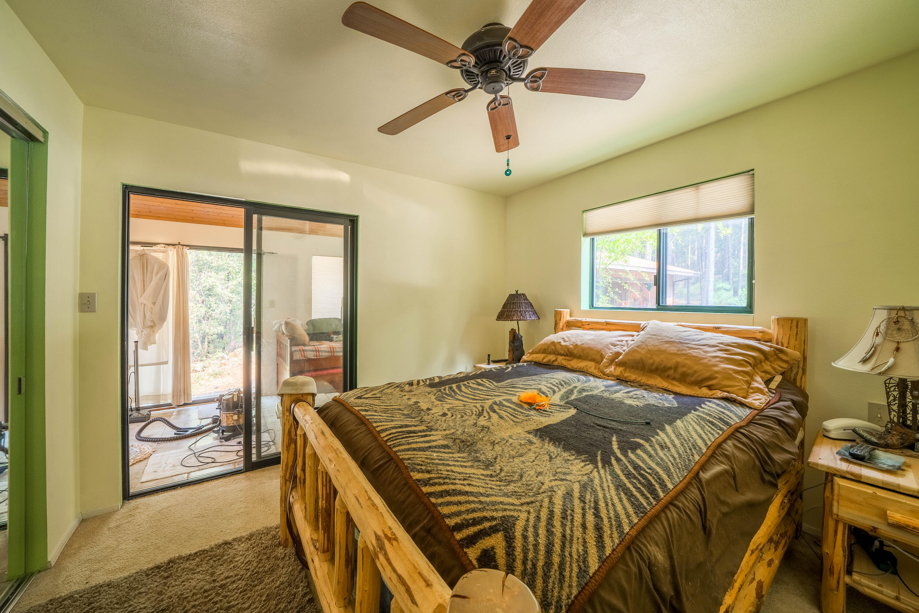 14245 Doe Run Road Whitmore, CA 96096 - Photo 14 of 34 a bedroom with a bed and a chandelier