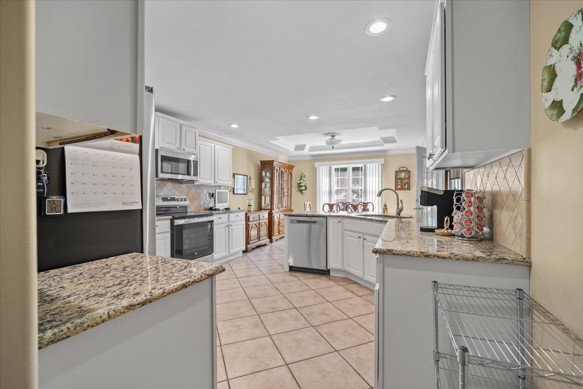 1721 Partridge Point Normal, IL 61761 - Photo 13 of 37 a kitchen with white cabinets and appliances