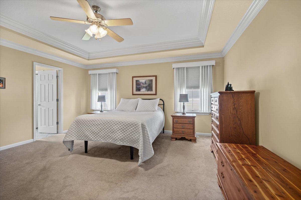 1721 Partridge Point Normal, IL 61761 - Photo 24 of 37 a spacious bedroom with a bed and a chandelier