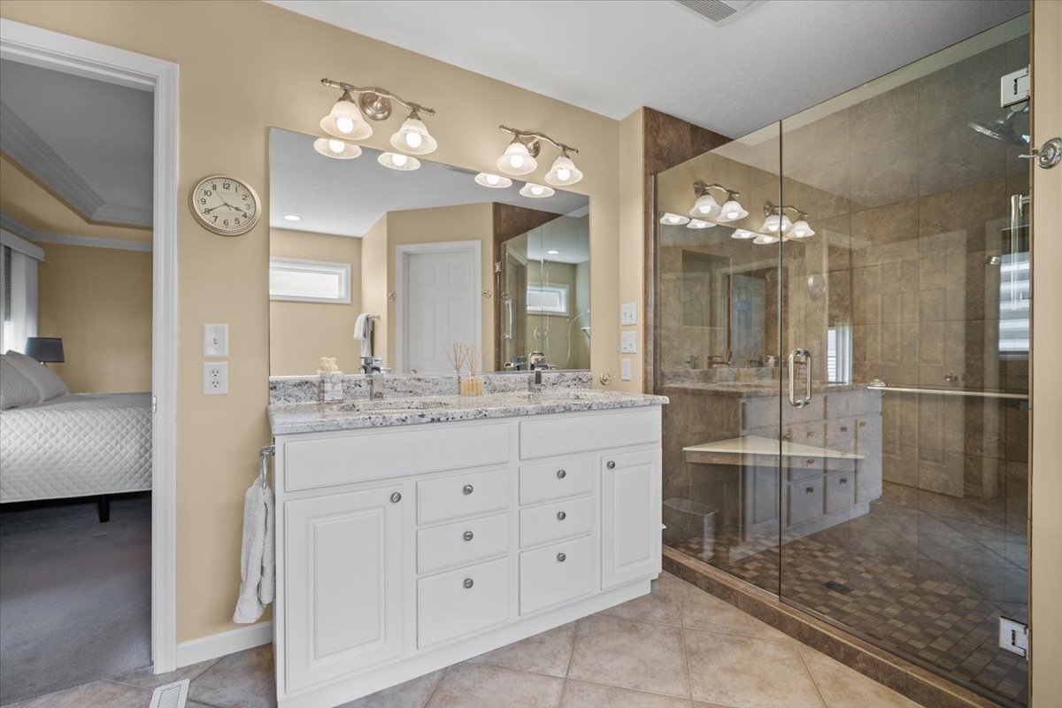 1721 Partridge Point Normal, IL 61761 - Photo 25 of 37 a bathroom with a granite countertop sink a large mirror and a shower