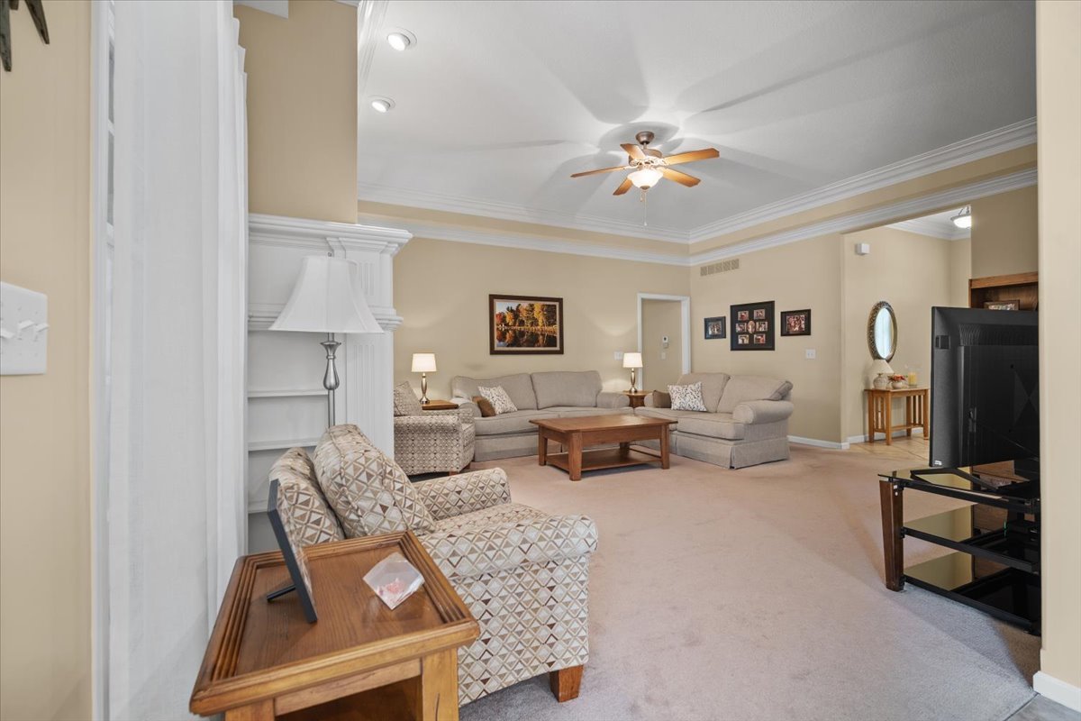 1721 Partridge Point Normal, IL 61761 - Photo 7 of 37 a living room with furniture a chandelier and a flat screen tv