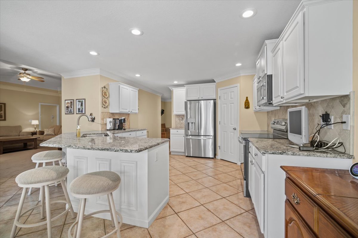 1721 Partridge Point Normal, IL 61761 - Photo 9 of 37 a kitchen with stainless steel appliances granite countertop a sink stove and cabinets