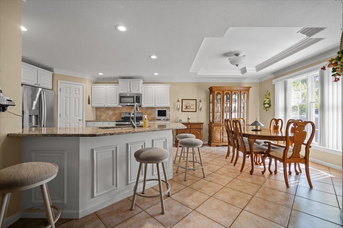 1721 Partridge Point Normal, IL 61761 - Photo 10 of 37 a kitchen with stainless steel appliances granite countertop a table and chairs in it