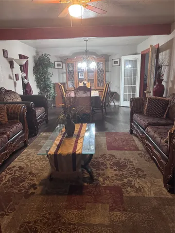 a living room with furniture and a chandelier