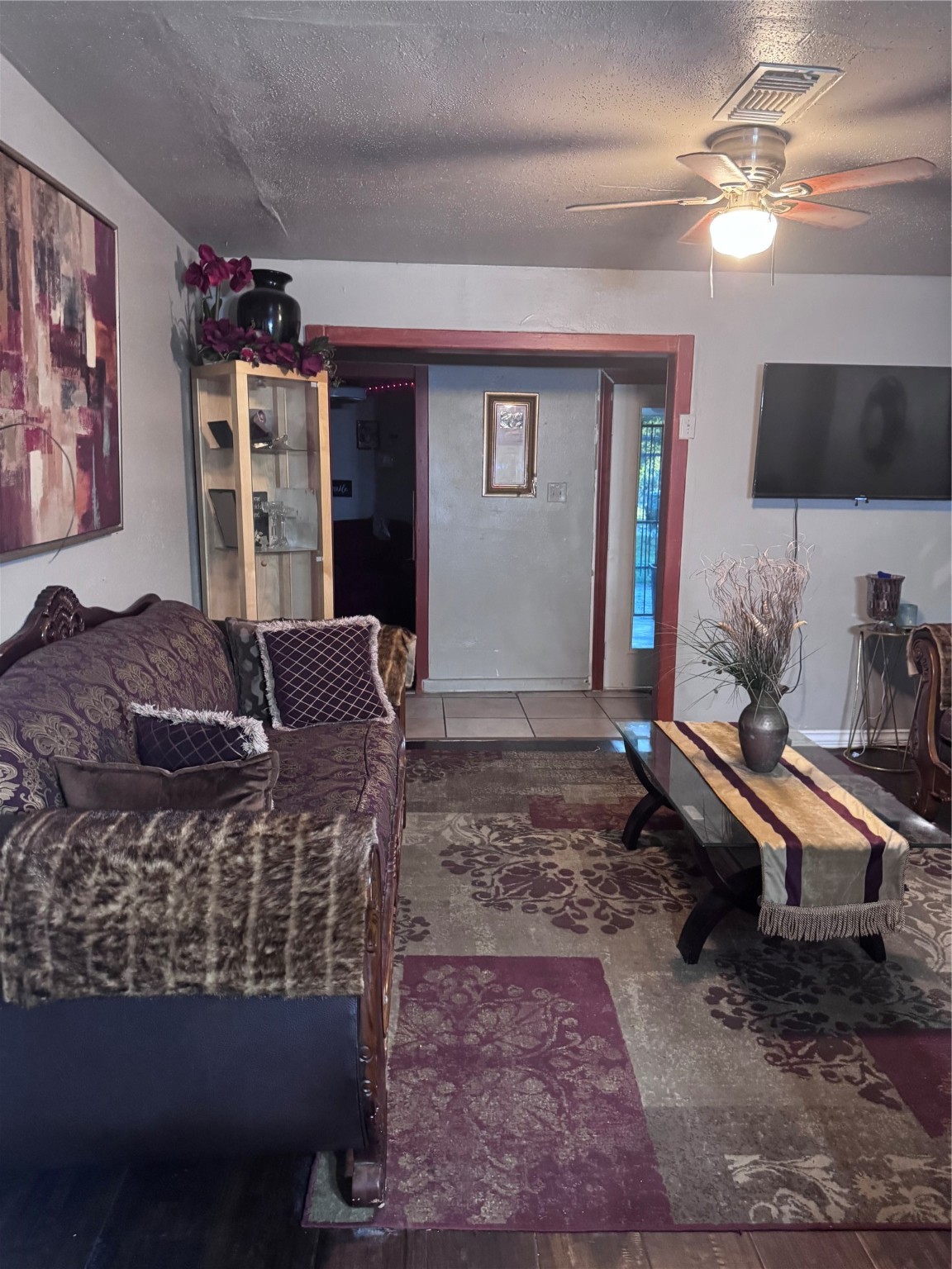2519 Garapan Street Houston, TX 77091 - Photo 3 of 7 a living room with furniture a flat screen tv and a window
