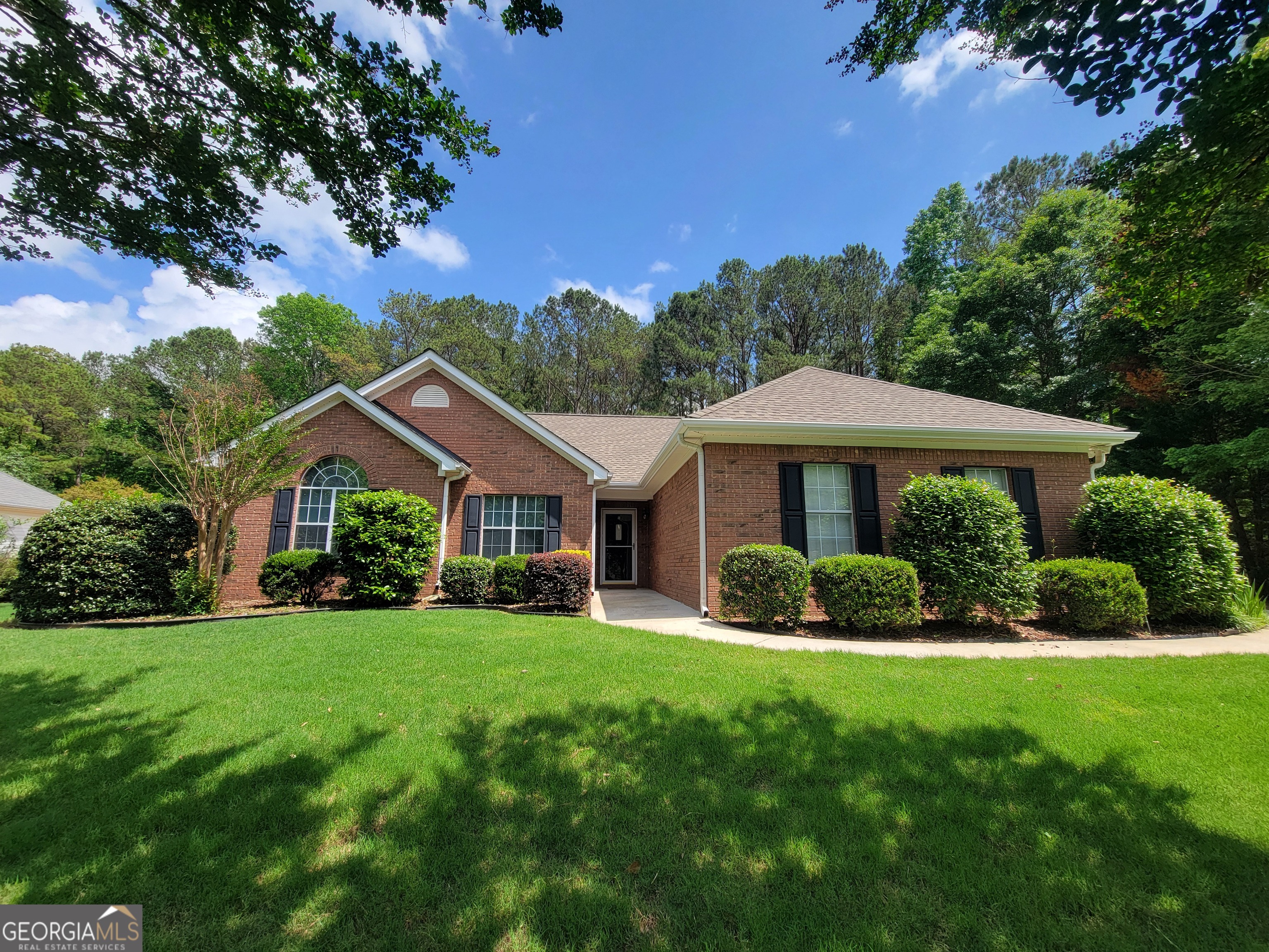a front view of a house with a yard