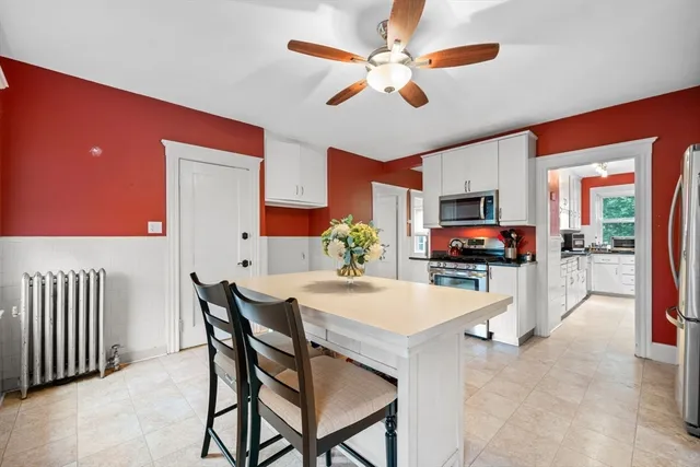 a view of a dining room with furniture and a chandelier
