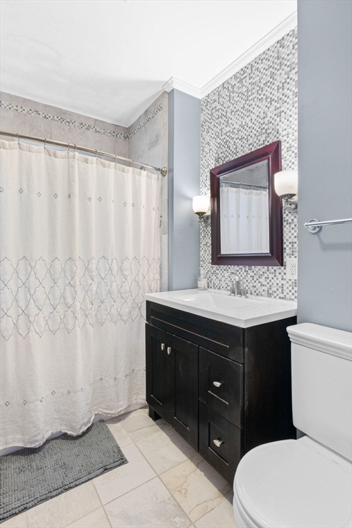 59 Leach Street, Unit 2 Salem, MA 01970 - Photo 18 of 38 a bathroom with a granite countertop sink toilet and mirror