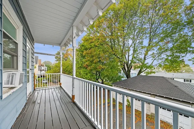 a view of a balcony with wooden floor