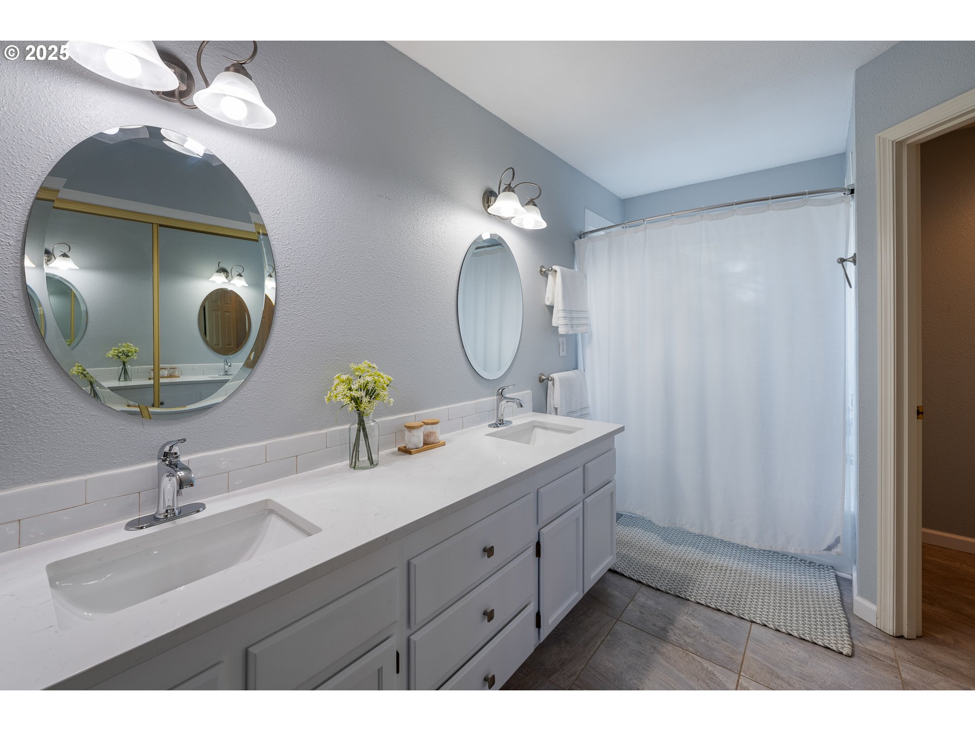 11450 Southwest Pintail Loop Beaverton, OR 97007 - Photo 19 of 35 a bathroom with a double vanity sink and a mirror