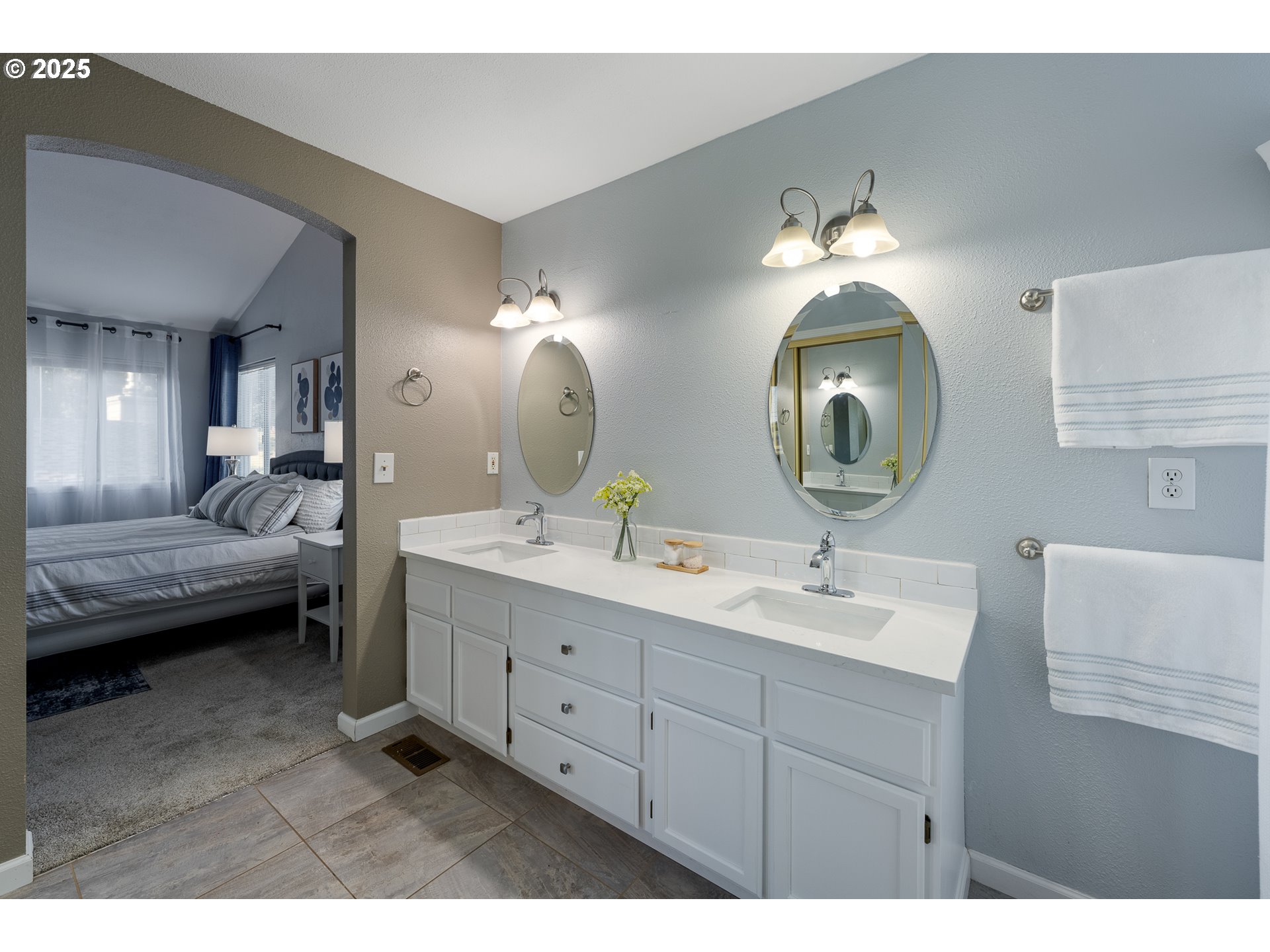 11450 Southwest Pintail Loop Beaverton, OR 97007 - Photo 21 of 35 a en suite bathroom with double vanity a sink and a mirror