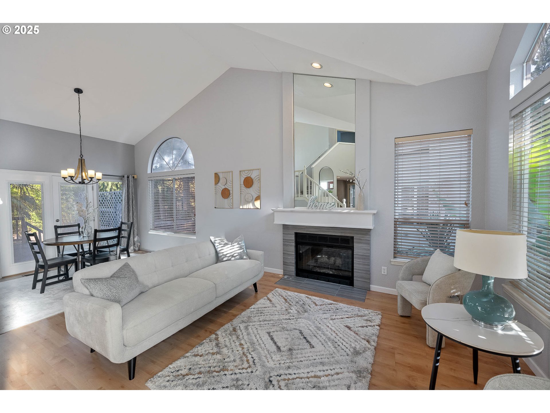 11450 Southwest Pintail Loop Beaverton, OR 97007 - Photo 3 of 35 a living room with furniture a fireplace and a table