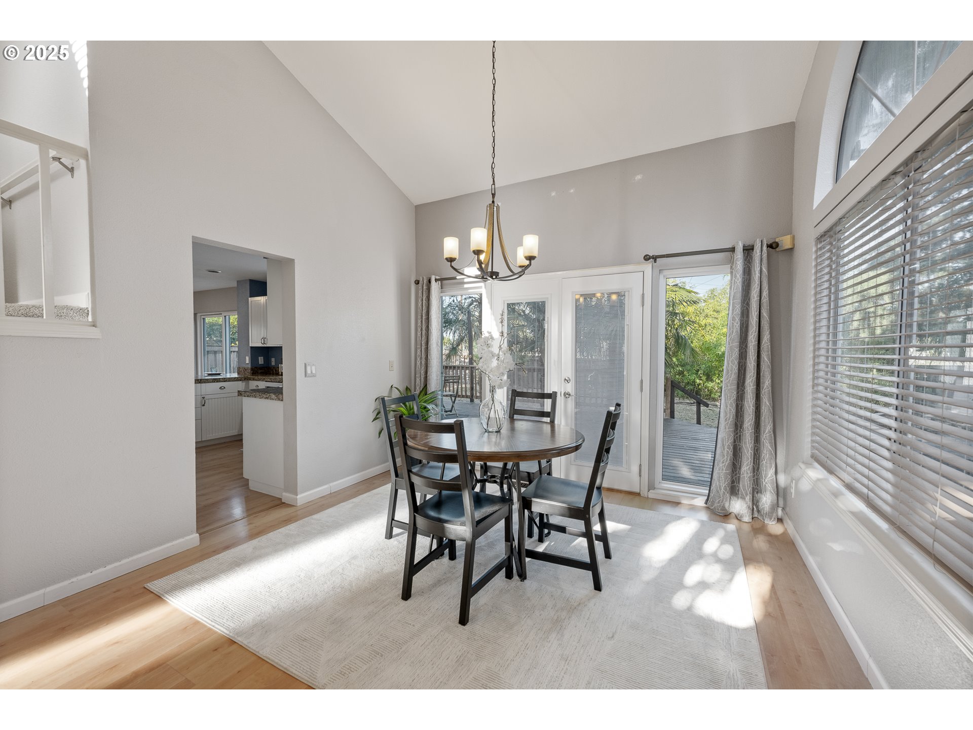 11450 Southwest Pintail Loop Beaverton, OR 97007 - Photo 5 of 35 a view of a dining room and livingroom with furniture window and wooden floor