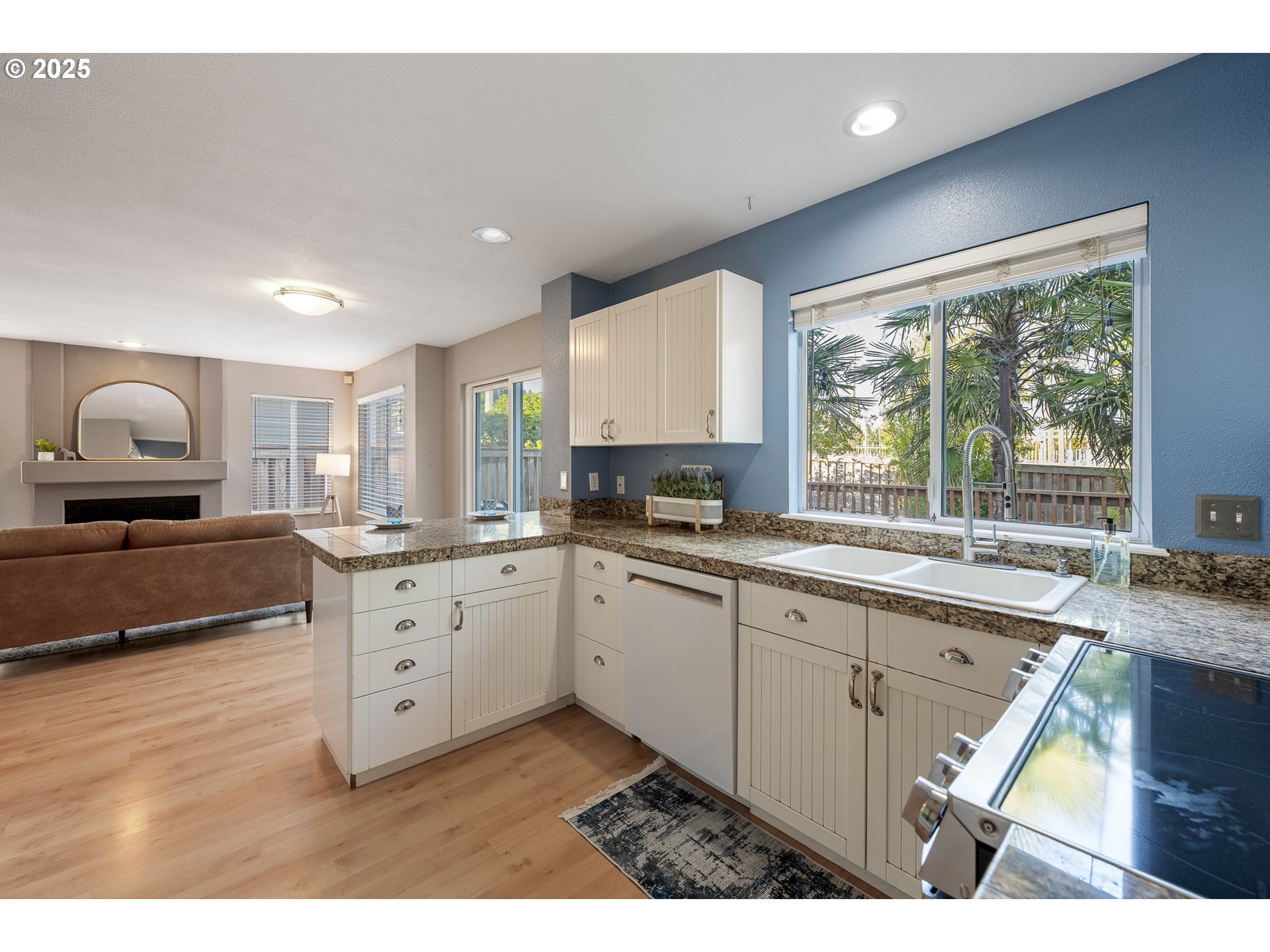11450 Southwest Pintail Loop Beaverton, OR 97007 - Photo 7 of 35 a kitchen with granite countertop a stove a sink and a refrigerator