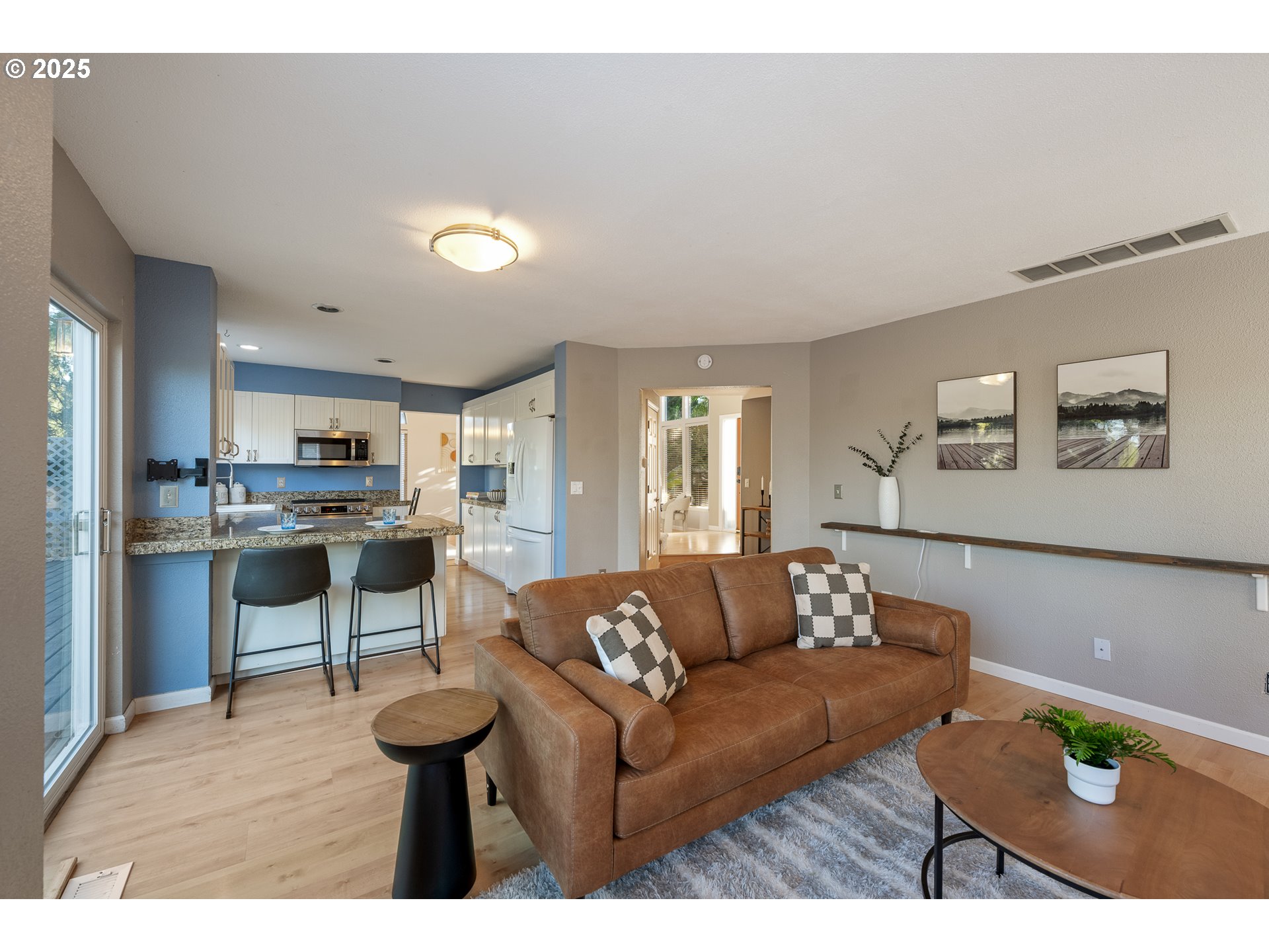 11450 Southwest Pintail Loop Beaverton, OR 97007 - Photo 10 of 35 a living room with stainless steel appliances kitchen island granite countertop furniture and a view of kitchen