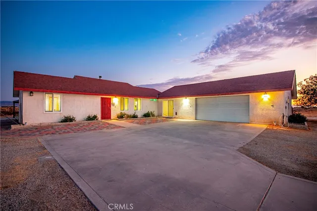 a view of a house with a yard and garage