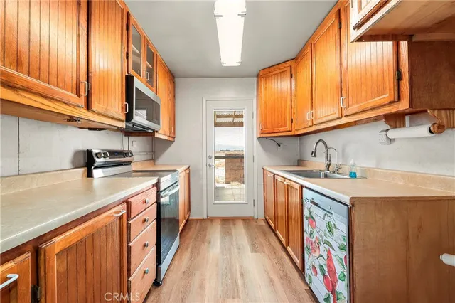 a view of an empty room with window and cabinet