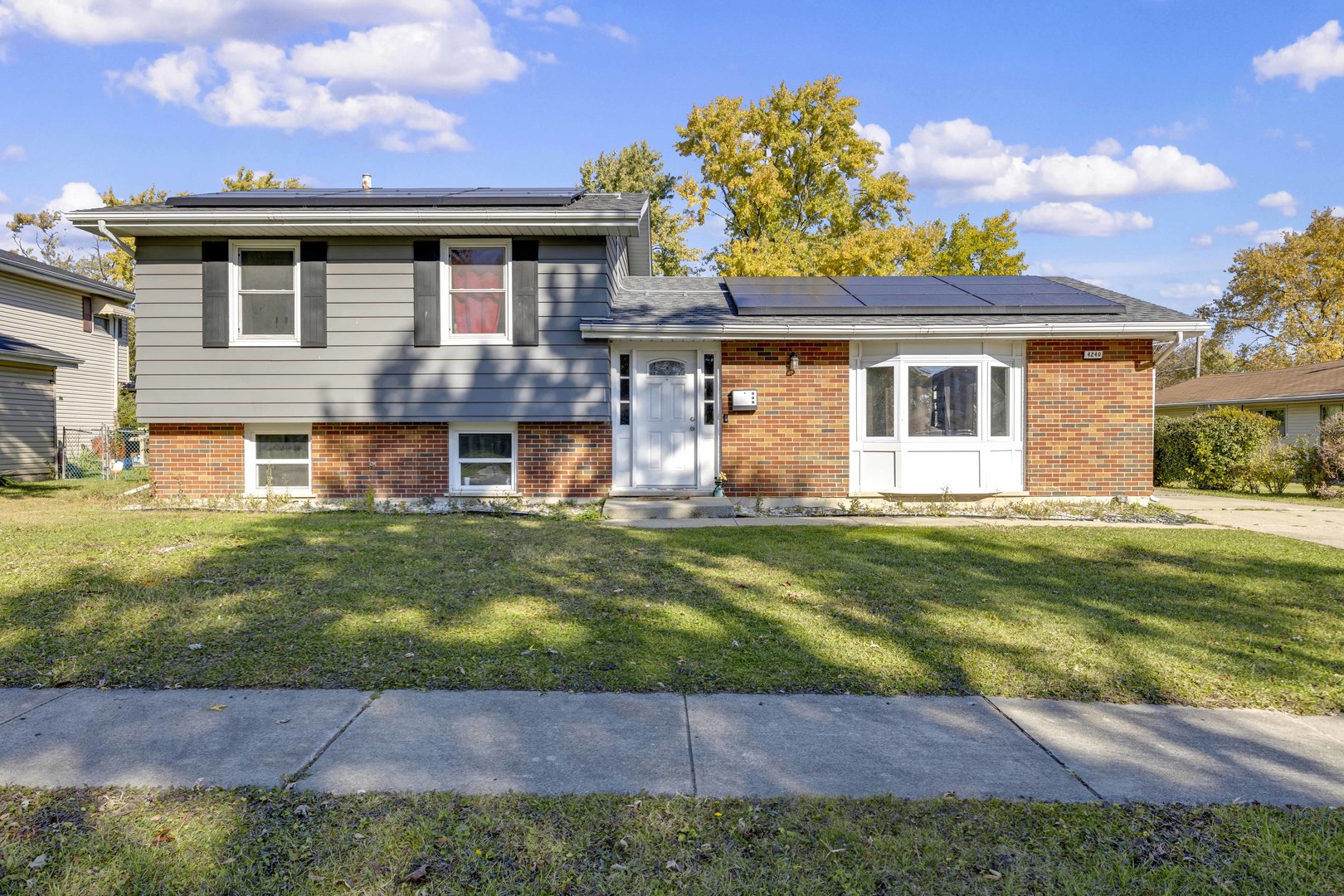 a front view of a house with a garden