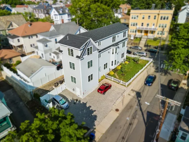 an aerial view of residential houses with outdoor space