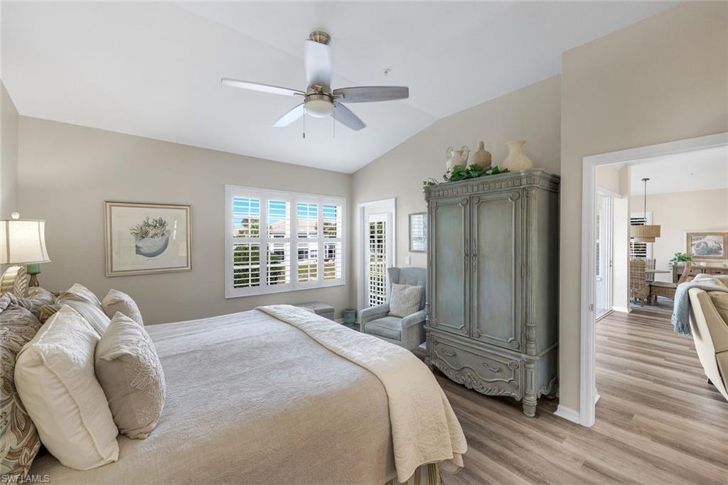 6879 Redbay Park Road, Unit 203 Naples, FL 34109 - Photo 20 of 43 Bedroom with vaulted ceiling, light wood-style flooring, and ceiling fan