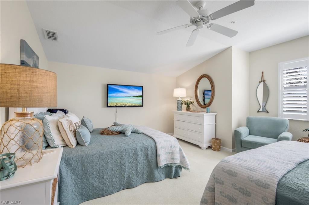 6879 Redbay Park Road, Unit 203 Naples, FL 34109 - Photo 23 of 43 Bedroom featuring vaulted ceiling, carpet floors, and a ceiling fan