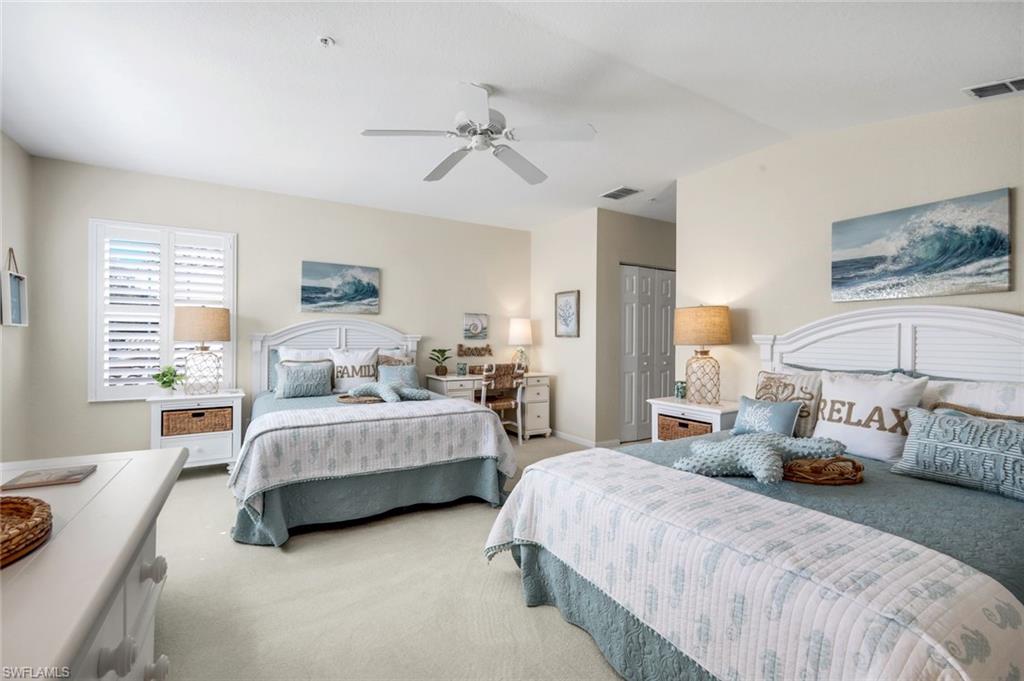 6879 Redbay Park Road, Unit 203 Naples, FL 34109 - Photo 24 of 43 Carpeted bedroom featuring a closet, a ceiling fan, and vaulted ceiling