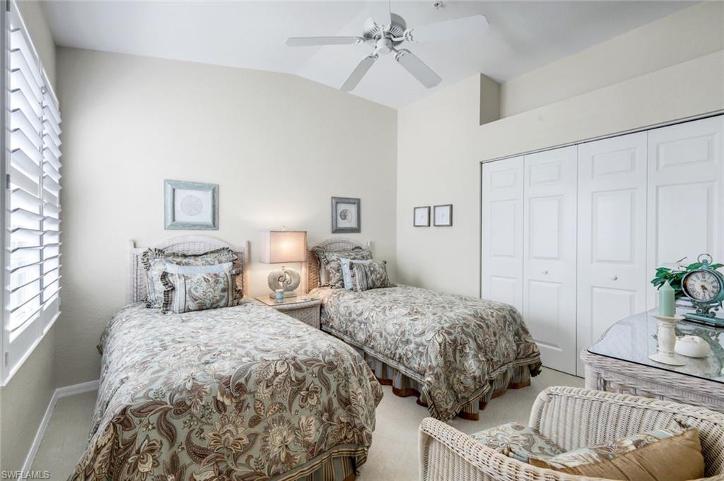 6879 Redbay Park Road, Unit 203 Naples, FL 34109 - Photo 26 of 43 Bedroom with vaulted ceiling, carpet floors, a closet, and a ceiling fan