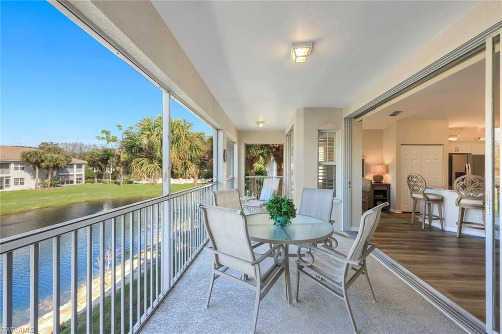 6879 Redbay Park Road, Unit 203 Naples, FL 34109 - Photo 32 of 43 Balcony with outdoor dining space and a water view