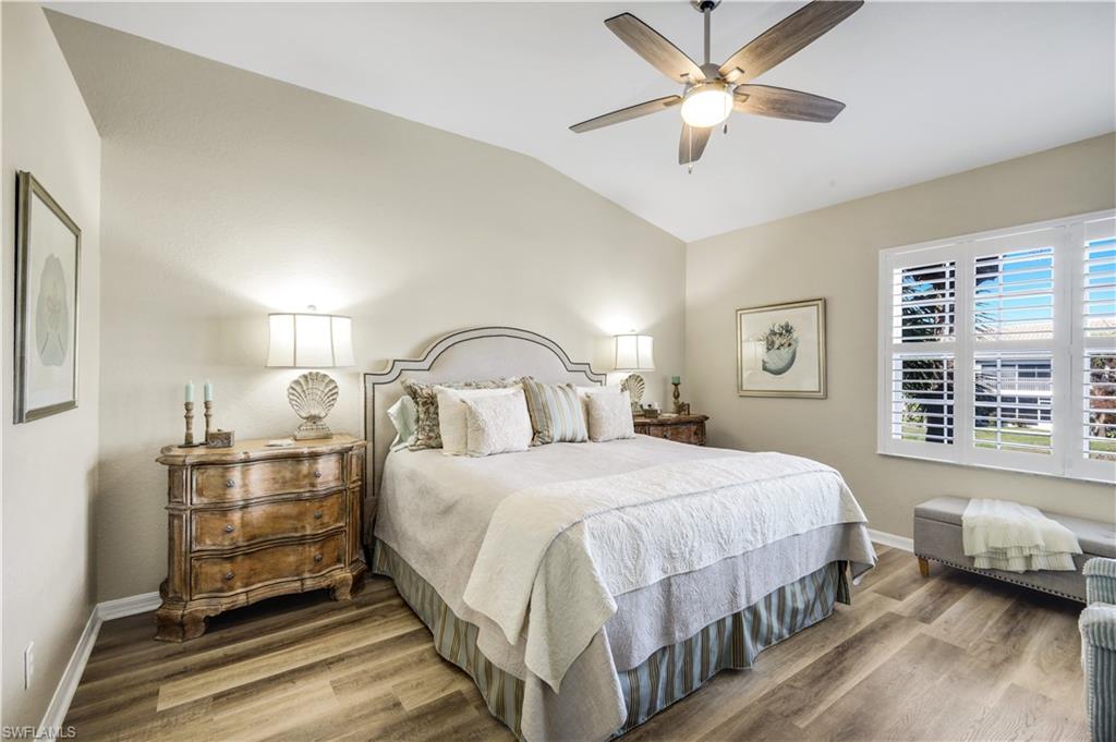 6879 Redbay Park Road, Unit 203 Naples, FL 34109 - Photo 35 of 43 Bedroom with lofted ceiling, wood finished floors, and ceiling fan