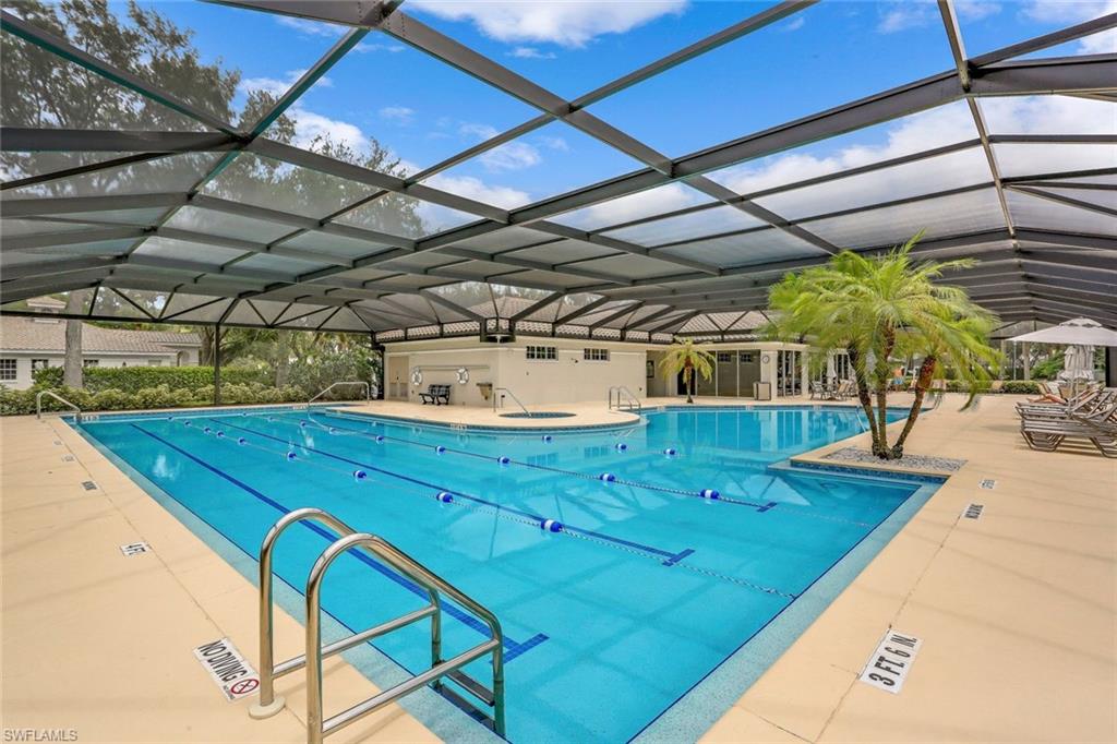 6879 Redbay Park Road, Unit 203 Naples, FL 34109 - Photo 39 of 43 Community pool with a lanai and a patio area