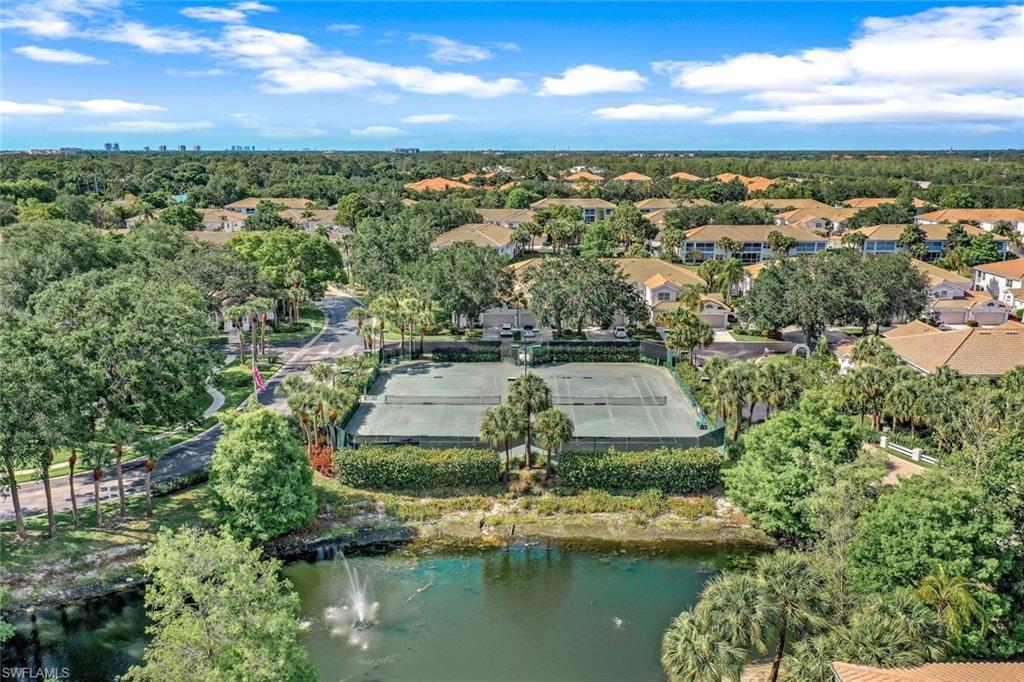6879 Redbay Park Road, Unit 203 Naples, FL 34109 - Photo 41 of 43 Drone / aerial view of a tree filled landscape and a large body of water