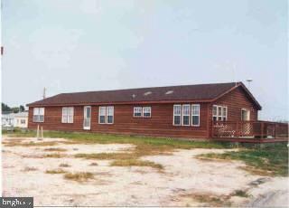 a view of a big house with a big yard and a large tree