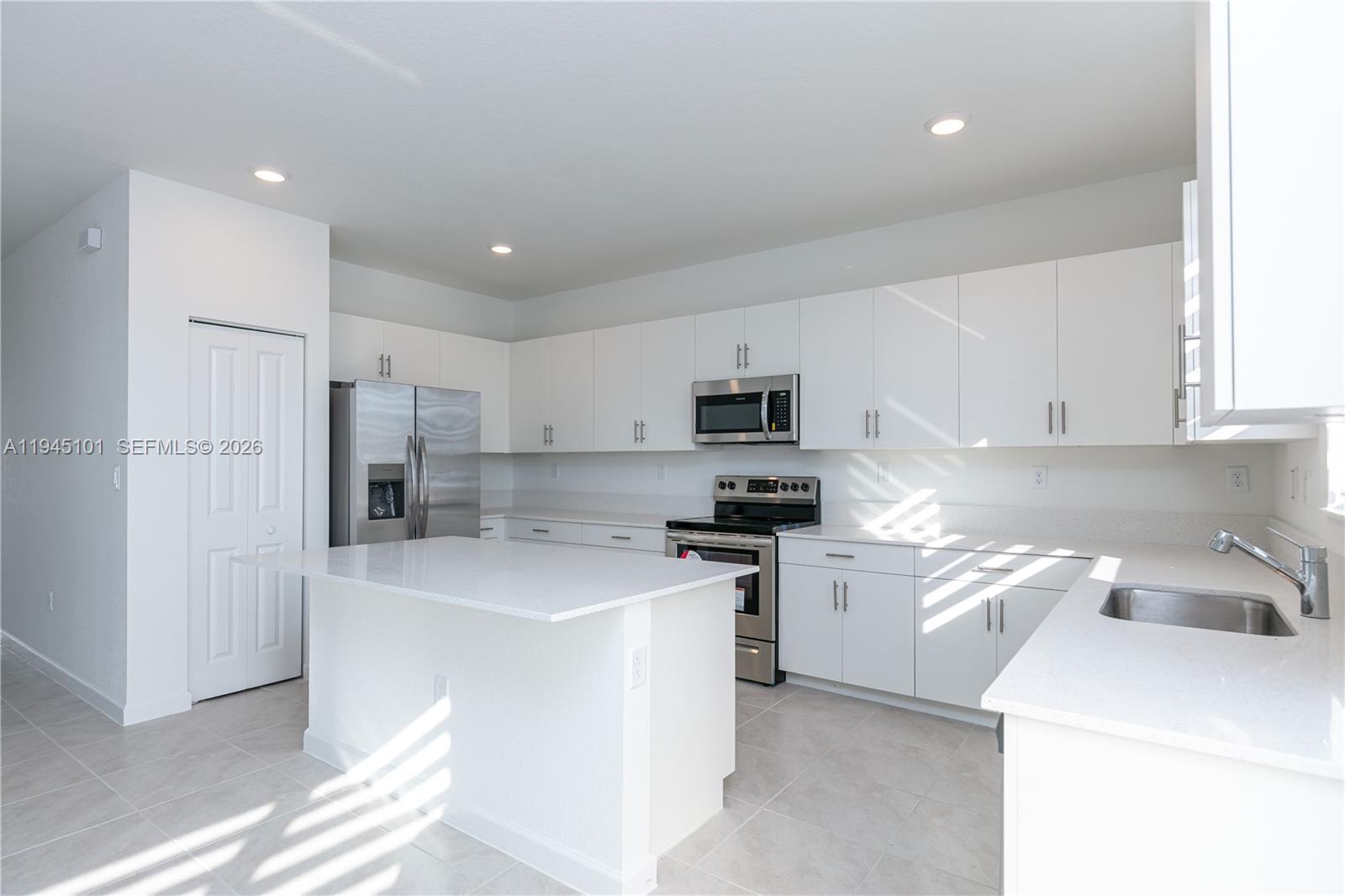 12990 Southwest 229th Lane Miami, FL 33170 - Photo 11 of 43 a kitchen with stainless steel appliances a sink a stove a refrigerator cabinets and a window