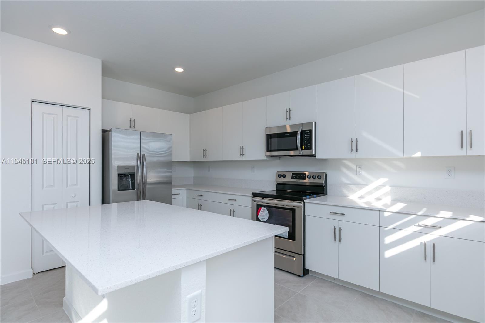 12990 Southwest 229th Lane Miami, FL 33170 - Photo 12 of 43 a kitchen with stainless steel appliances a refrigerator sink stove microwave and cabinets