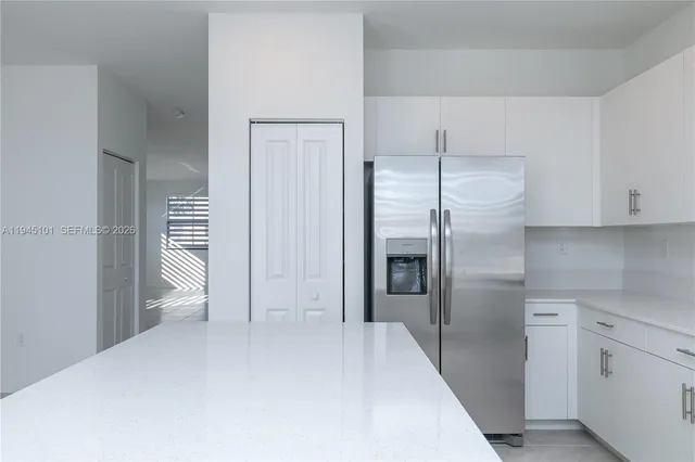 a kitchen with a sink a stove and cabinets