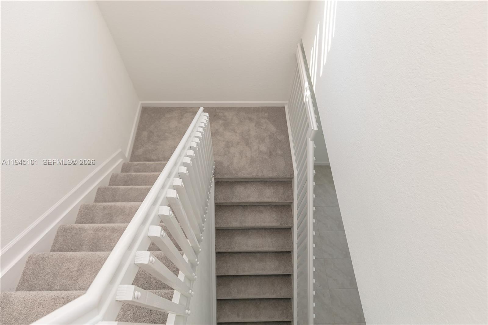 12990 Southwest 229th Lane Miami, FL 33170 - Photo 16 of 43 a view of staircase with white walls and white door