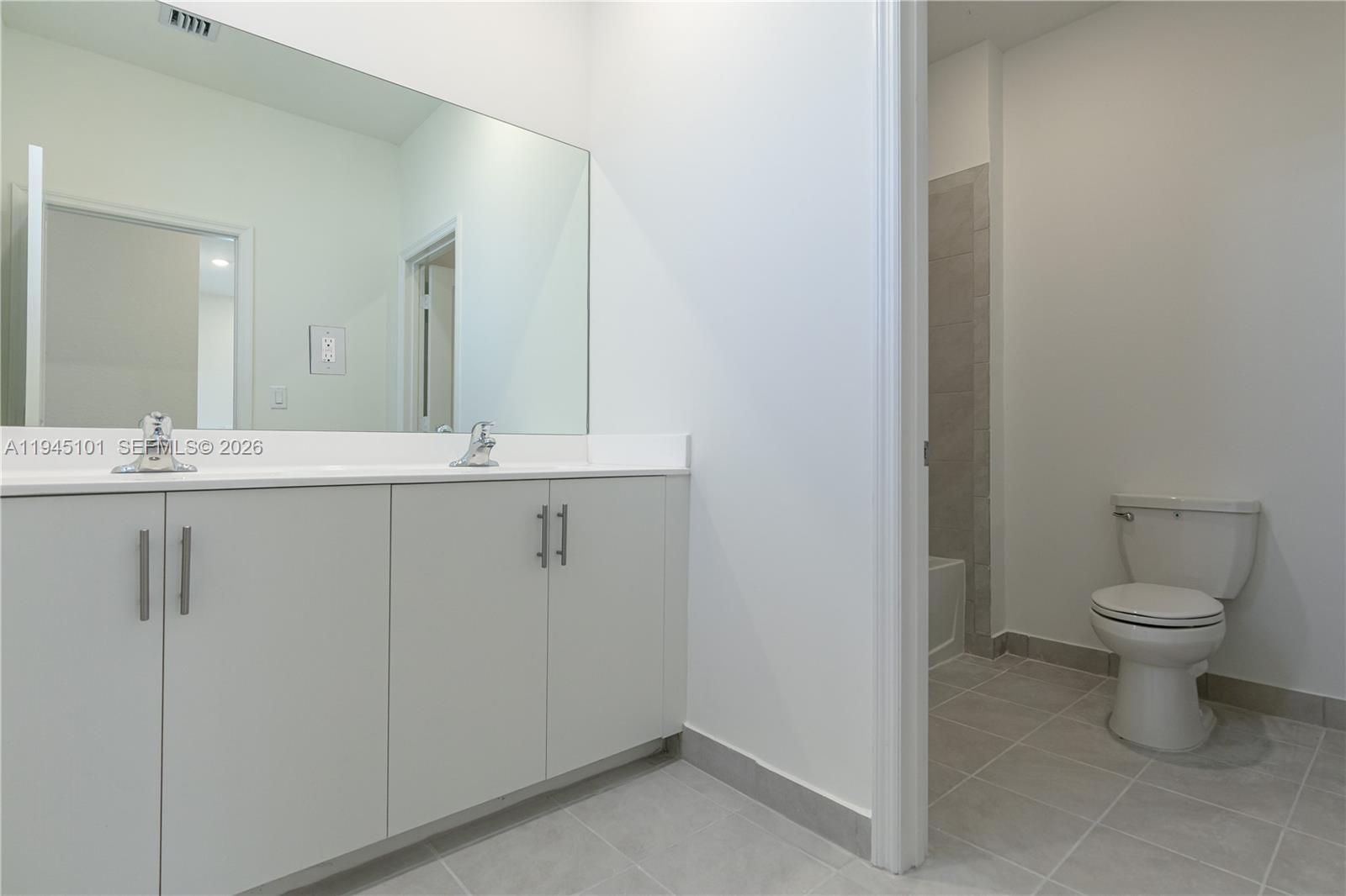 12990 Southwest 229th Lane Miami, FL 33170 - Photo 29 of 43 a bathroom with a granite countertop sink a toilet and a mirror