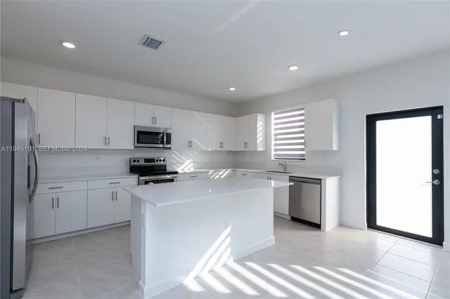 a view of an empty room with stairs