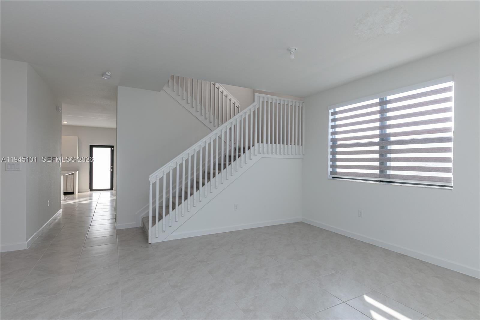 12990 Southwest 229th Lane Miami, FL 33170 - Photo 9 of 43 a view of an empty room with stairs