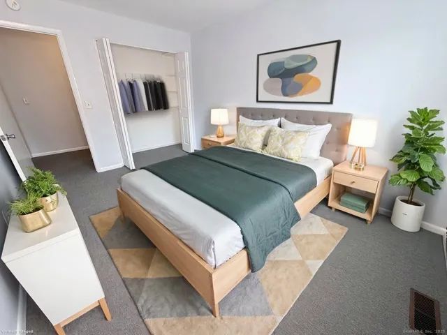 a bedroom with bed and a couch