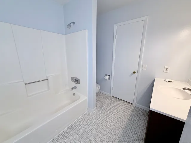 a bathroom with a bathtub and a sink