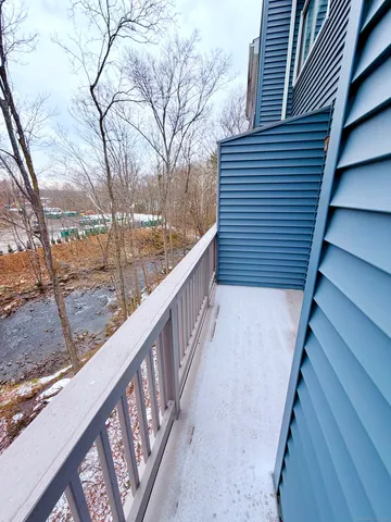 a view of balcony with wooden floor and fence