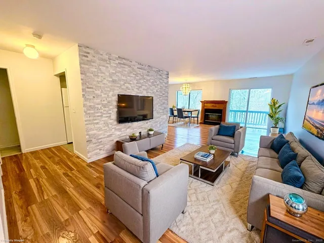 a living room with furniture flat screen tv and a fireplace