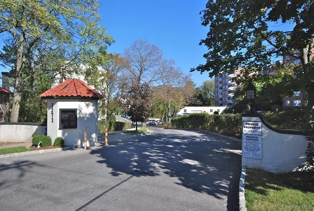 a front view of a house with yard and trees