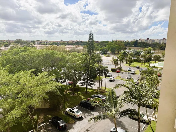 a view of swimming pool with outdoor seating and city view