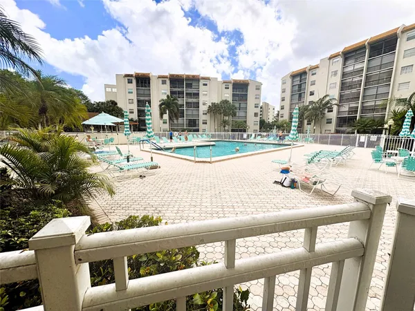 a view of a patio with a table and chairs