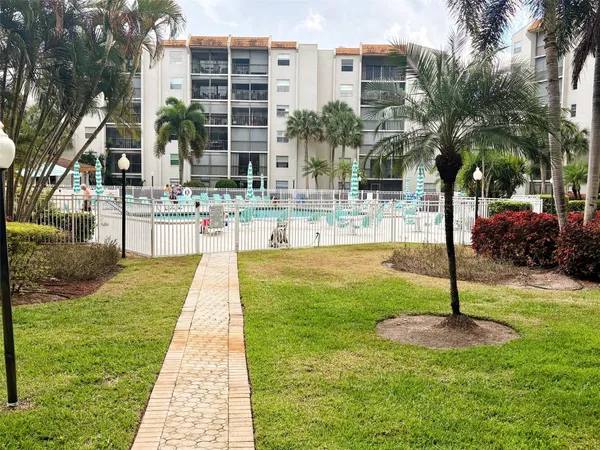 a view of a swimming pool and a yard